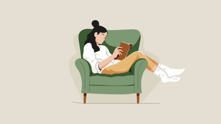 Woman sitting in a chair reading a book