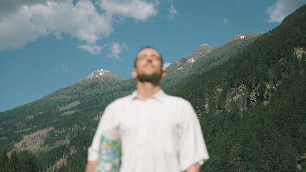 Man standing in front of mountainscape