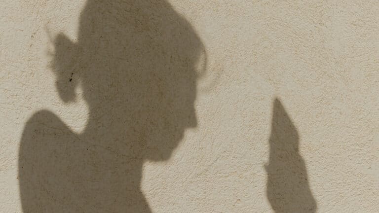 Shadow of a woman using a mobile phone