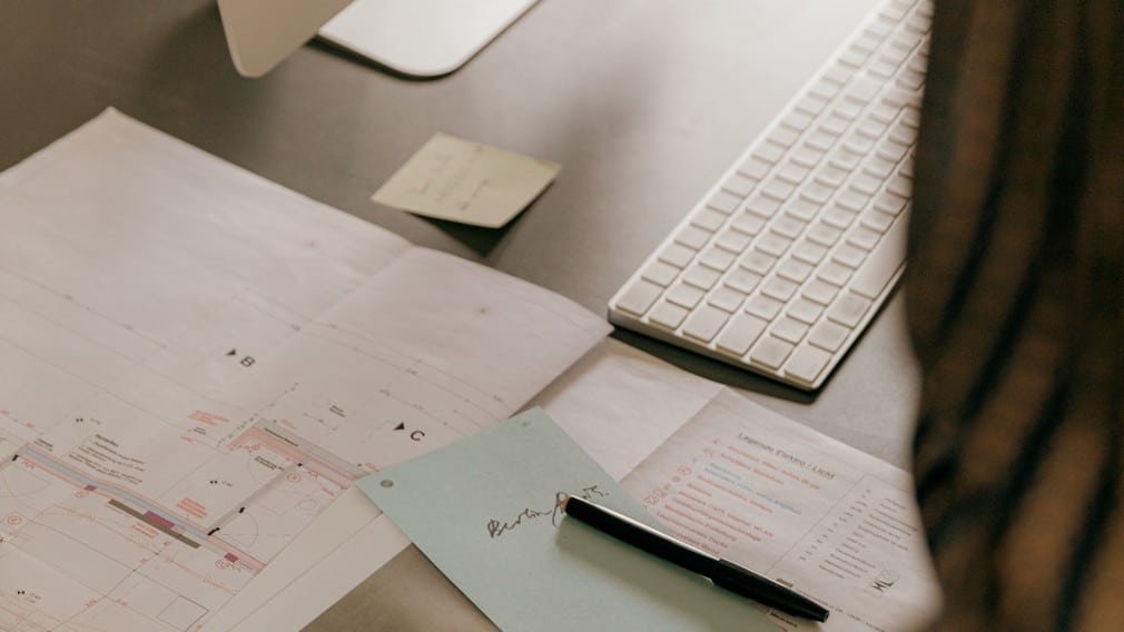 Computer and plans on a desktop